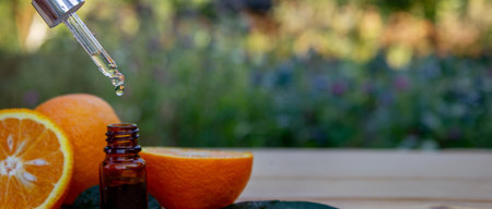 Essential extract of orange oil in a small bottle.の写真素材