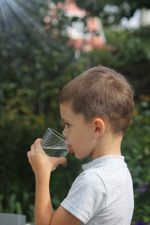 Child drinks water. Selective focusNatureの写真素材