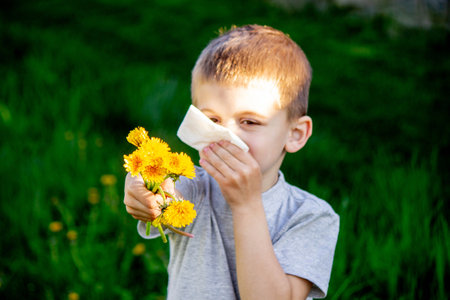 the child is allergic to spring flowers. Selective focus.の写真素材