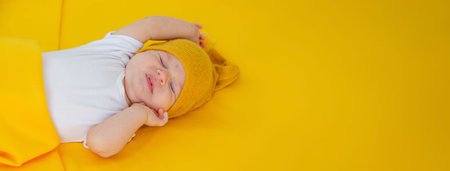 baby sleeps on a yellow background. child.