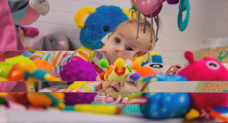 a child plays with hanging toys on a play mat. the child plays with toys at home