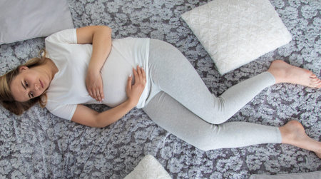 Pregnant woman has stomach ache. Selective focus. Home.