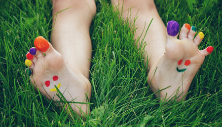 a smile drawn with paints on a child's legs.の写真素材