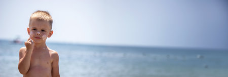 the child applies sun cream on himself. protection from the sunの写真素材