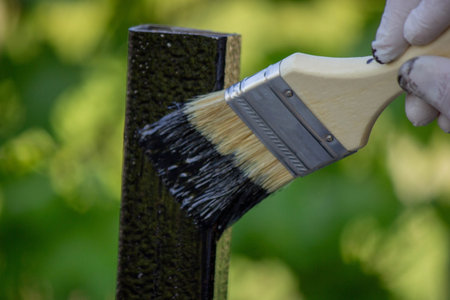 close-up of a hand painting a metal pipe. Selective focus.の写真素材