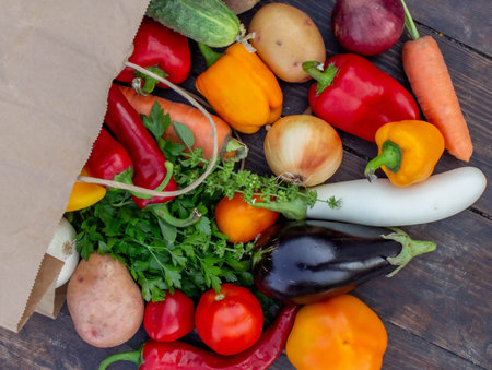 fresh vegetables on a wooden background in a paper bag. Selective focus.