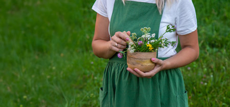 A woman collects medicinal herbs.の写真素材