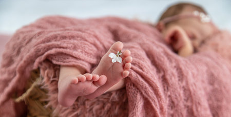 newborn baby sleeping on a pink backgroundの写真素材