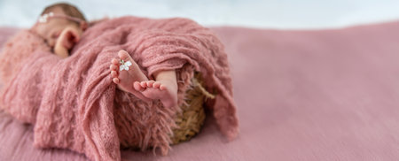 newborn baby sleeping on a pink backgroundの写真素材