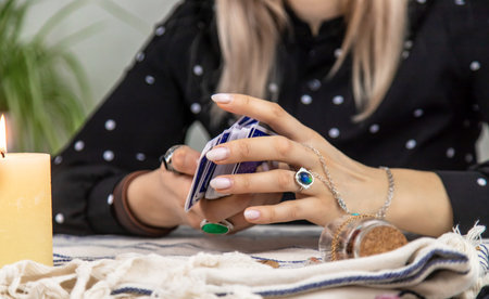 A fortune teller reads with tarot cards. Selective focus. Woman.