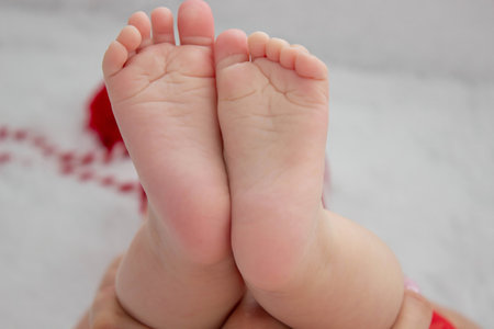 Soft feet of a newborn. Close-up of the fingers, heels and feet of a newborn. Macro shot of a tiny foot of a newborn baby.の写真素材