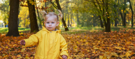 little girl in a beautiful autumn park. Golden autumnの写真素材
