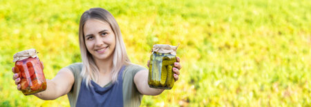 A woman preserves vegetables in jars. Selective focus.