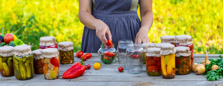 A woman preserves vegetables in jars. Selective focus