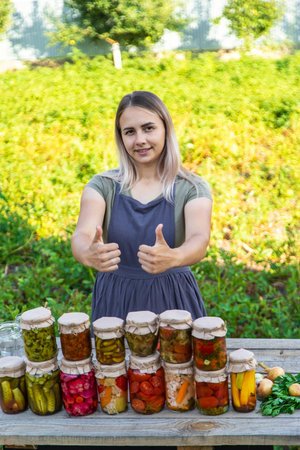 A woman preserves vegetables in jars. Selective focusの写真素材