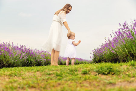 Happy mother and daughter in a lavender field.の写真素材