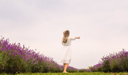 Happy mother and daughter in a lavender field.の写真素材