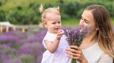 Happy mother and daughter in a lavender field.の写真素材