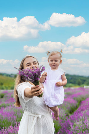 Happy mother and daughter in a lavender field.の写真素材