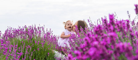 Happy mother and daughter in a lavender field.の写真素材