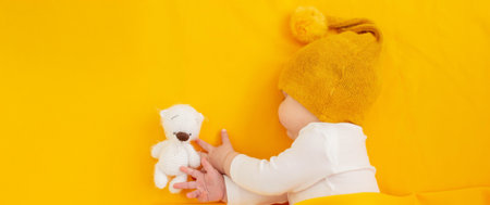 Baby sleeps on a yellow background. Selective focus.の写真素材