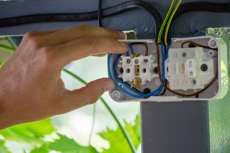 Male electrician installing socket. Selective focus.の写真素材