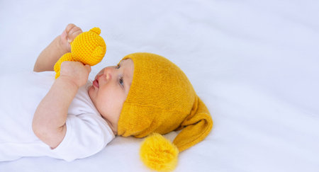 A child walks with a little teddy bear and gets ready for bedの写真素材