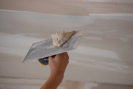 man plastering ceiling repair. Selective focus.の写真素材