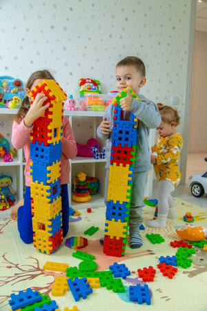Children playing with toys in the room. Selective focus.の写真素材
