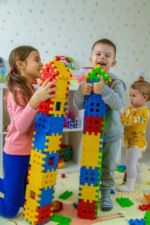 Children playing with toys in the room. Selective focus.の写真素材