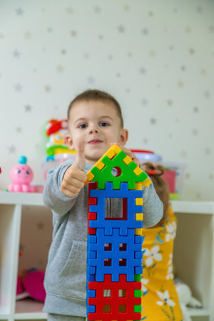 Boy playing with toys in the room. Selective focus.の写真素材
