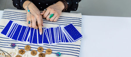 A fortune teller reads with tarot cards. Selective focus. Woman.
