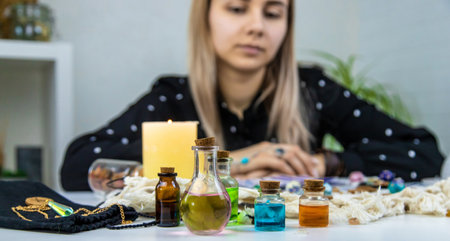 Woman fortune teller prepares a potion. Selective focus. People.の写真素材