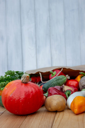 Fresh Organic Vegetables in Paper Bag on Wooden Background.の写真素材