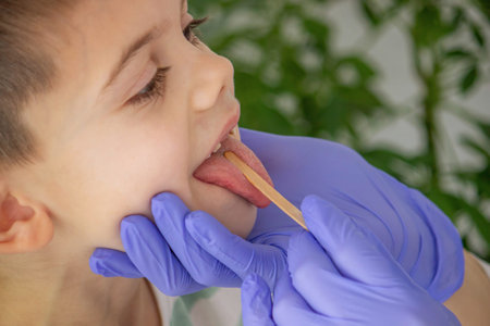 doctor looking into child's mouth, throat. pediatrician's appointment