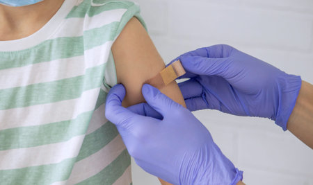 The doctor is vaccinating a child, a boy. Pediatrician's appointment, healthcare concept.