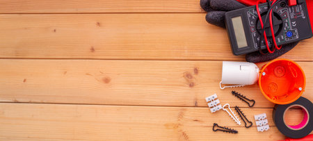 Electrical Tools and Components on Wooden Background.