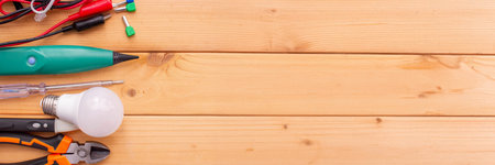 Electrical Tools and Components on Wooden Background.