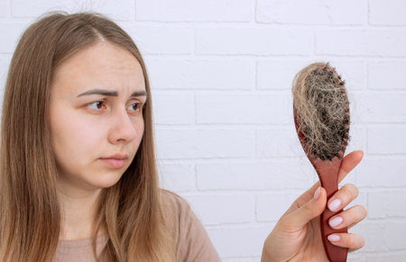 Woman's hair is falling out. hairbrush,hair loss.の写真素材