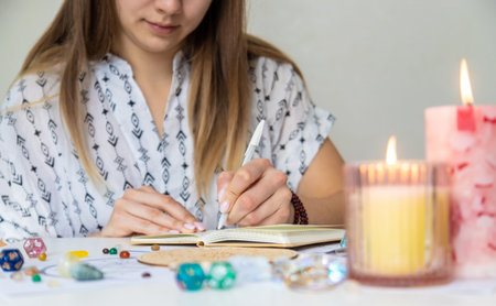 Woman astrologer draws a natal chart. Selective focus.