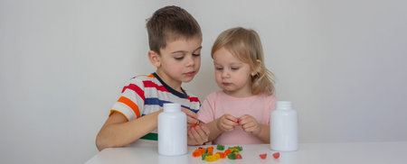 Children eating jelly candies. Deliciousness and vitaminsの写真素材
