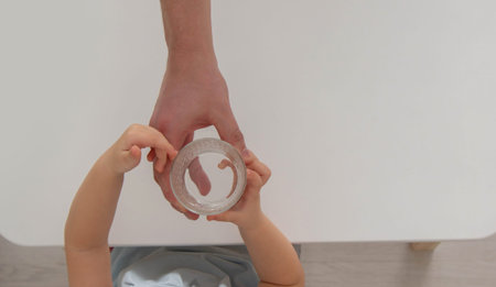 little girl drinks water from a glass. Selective focus.の写真素材