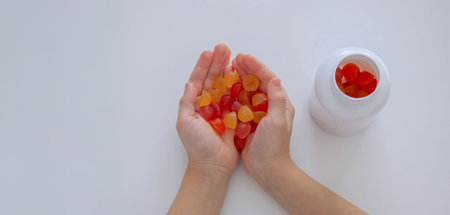The boy eats jelly beans.の写真素材