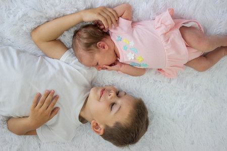 Older brother and newborn baby girl. childrenの写真素材