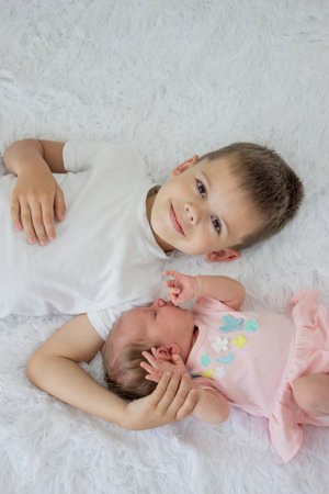 Older brother and newborn baby girl. childrenの写真素材