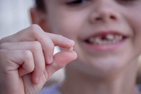 A child has lost a baby tooth. Kid.Concept baby tooth.の写真素材