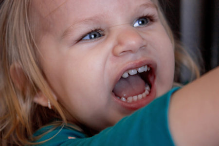 Beautiful and healthy baby teeth in a little girl. The baby's mouth with a milk tooth.