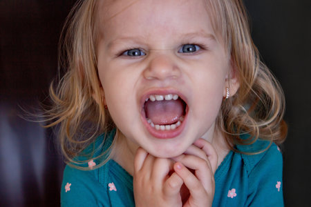 Beautiful and healthy baby teeth in a little girl. The baby's mouth with a milk tooth.の写真素材