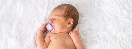 baby sleeping with a pacifier on a light background. pacifier, habit