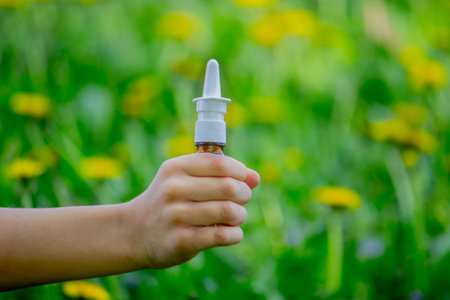 Children's allergy to flowers. Boy on a background of dandelions, allergy, sneezing.の写真素材